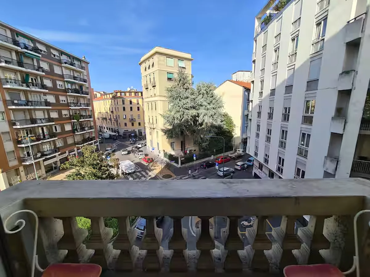 Balcony view across surrounding Milan streets and buildings.