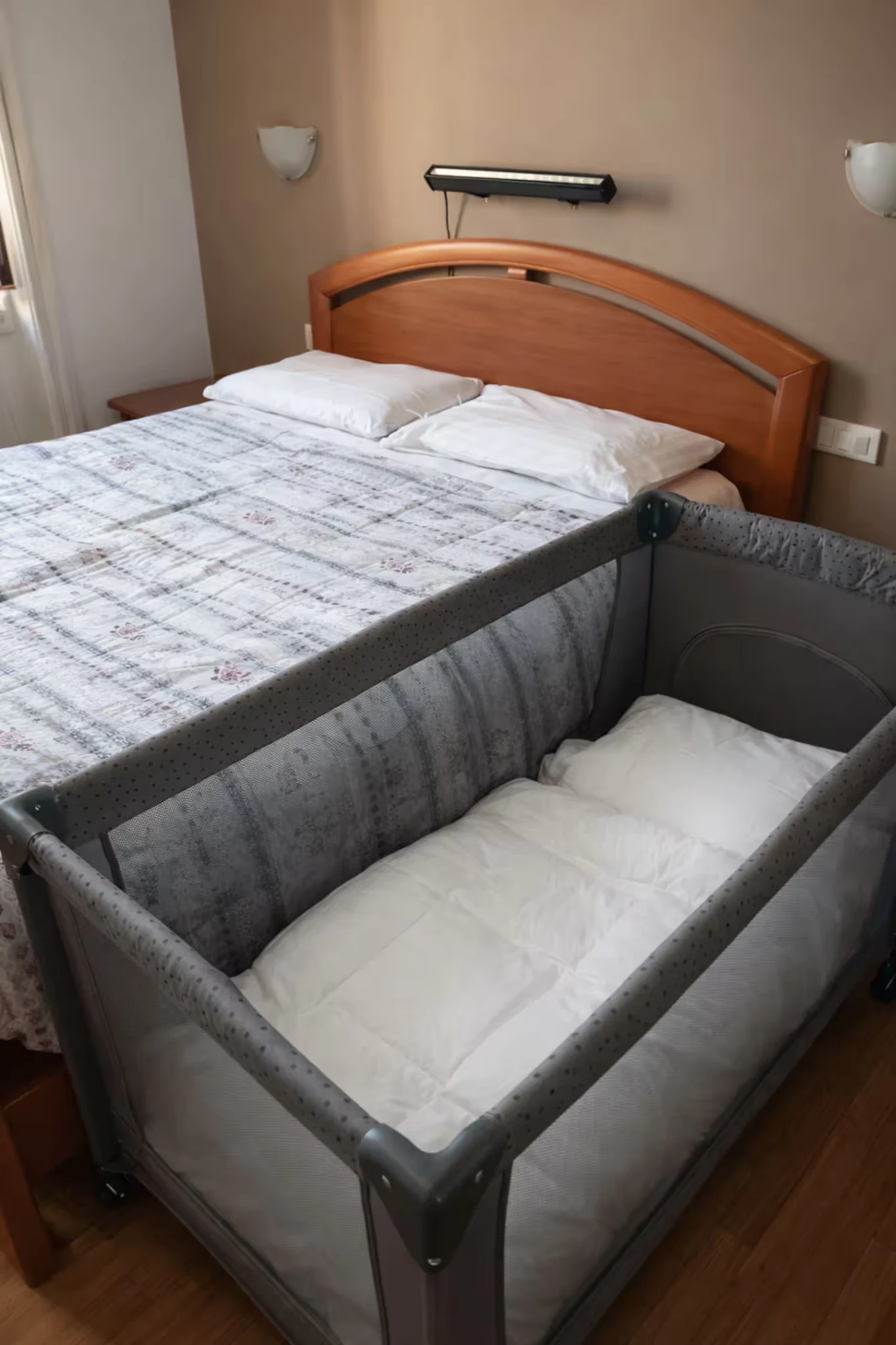 Bedroom with double bed and travel cot for families with children.