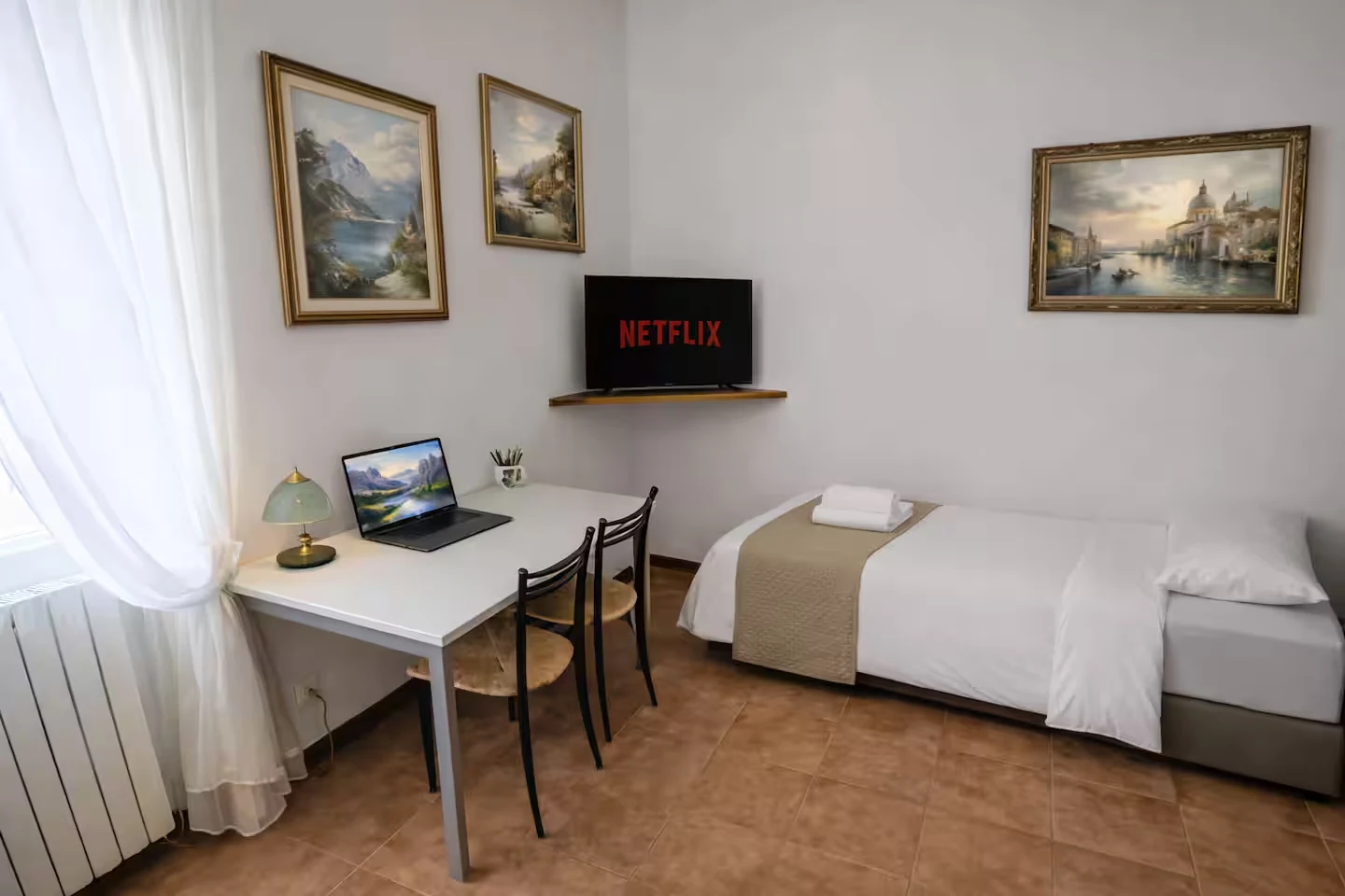 Clean extra room with desk, TV and a single bed for flexible longer stays.